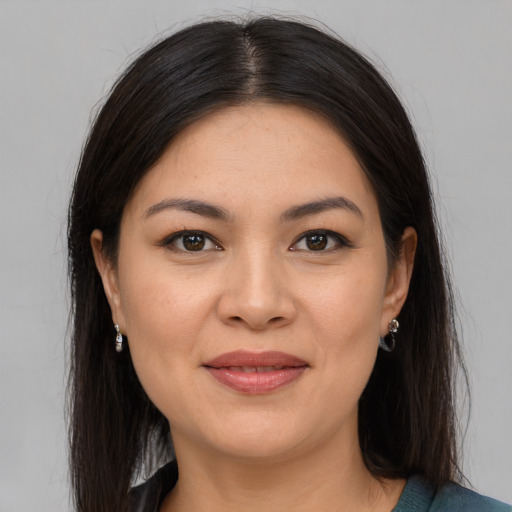 Joyful latino young-adult female with medium  brown hair and brown eyes
