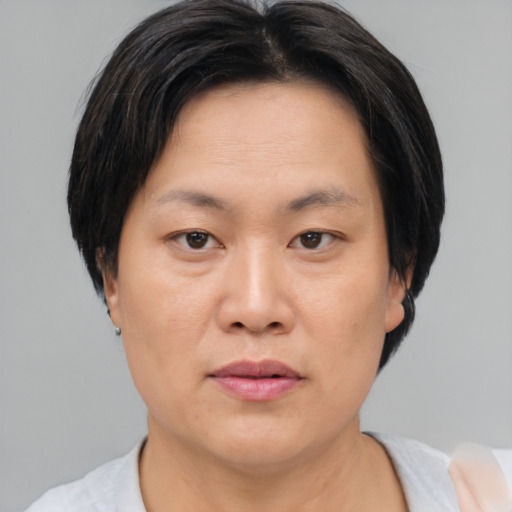Neutral asian adult female with short  brown hair and brown eyes