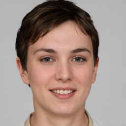 Joyful white young-adult female with short  brown hair and grey eyes