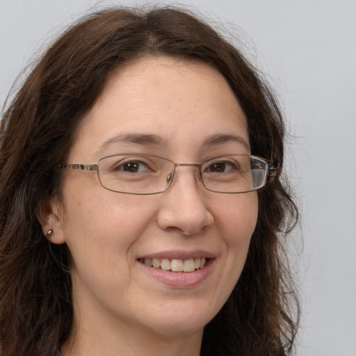 Joyful white adult female with long  brown hair and brown eyes