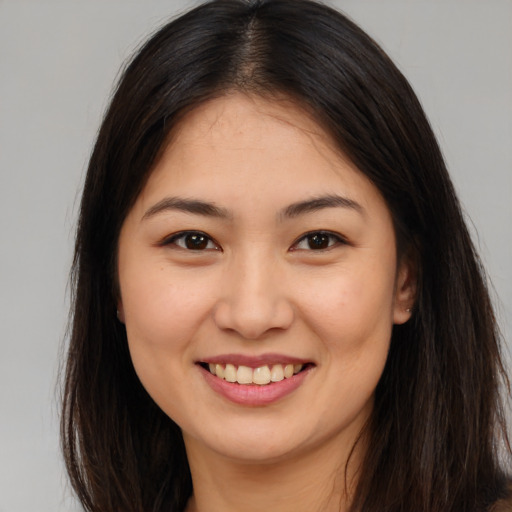 Joyful asian young-adult female with long  brown hair and brown eyes