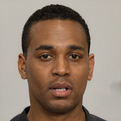 Neutral black young-adult male with short  black hair and brown eyes