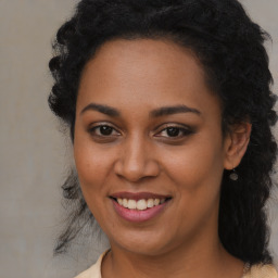 Joyful black young-adult female with long  brown hair and brown eyes