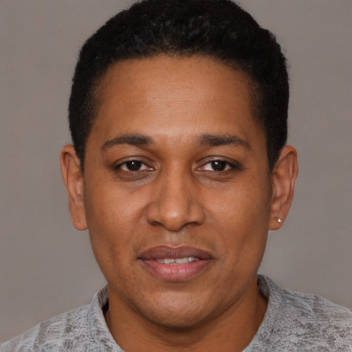 Joyful latino adult male with short  black hair and brown eyes