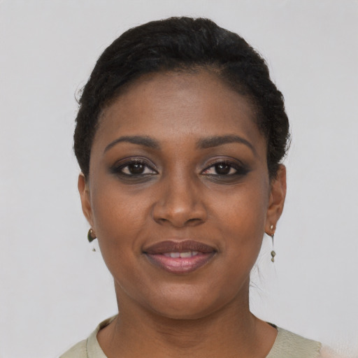 Joyful black young-adult female with short  black hair and brown eyes
