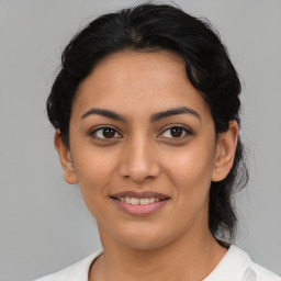 Joyful latino young-adult female with medium  black hair and brown eyes