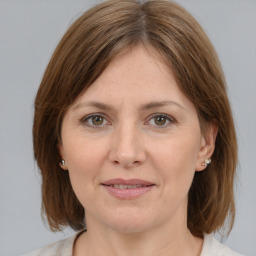 Joyful white adult female with medium  brown hair and grey eyes