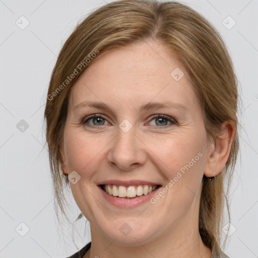 Joyful white adult female with medium  brown hair and grey eyes