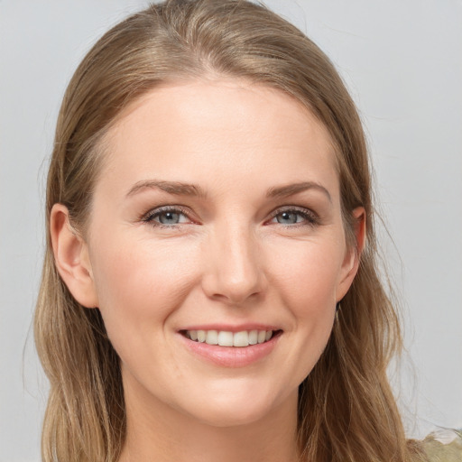 Joyful white young-adult female with long  brown hair and grey eyes