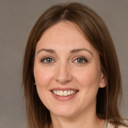 Joyful white young-adult female with medium  brown hair and grey eyes