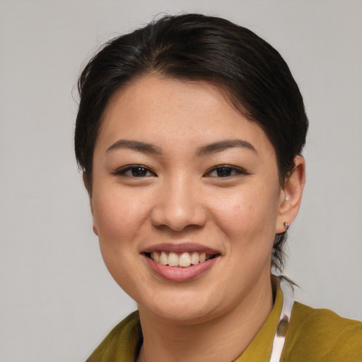 Joyful asian young-adult female with short  brown hair and brown eyes