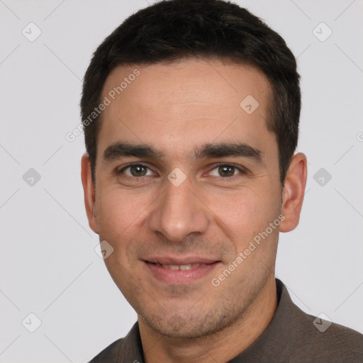 Joyful white young-adult male with short  black hair and brown eyes