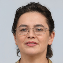 Joyful white adult female with short  brown hair and grey eyes