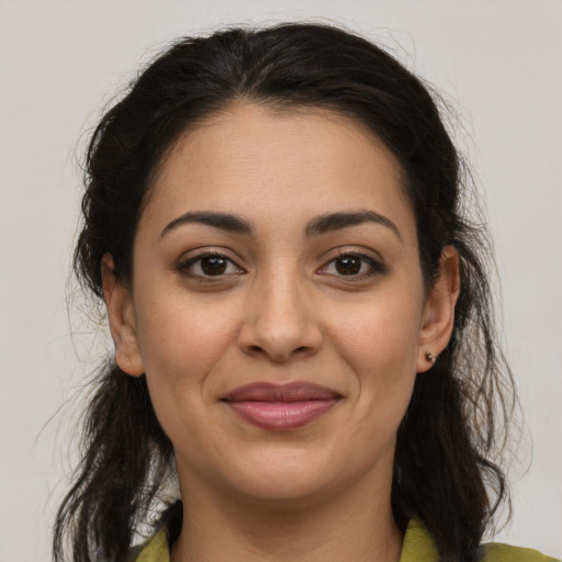 Joyful latino young-adult female with medium  brown hair and brown eyes