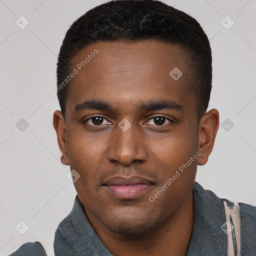 Joyful black young-adult male with short  black hair and brown eyes