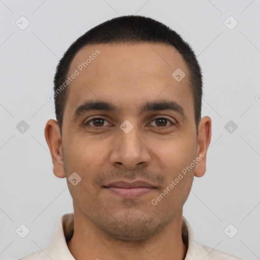 Joyful latino young-adult male with short  black hair and brown eyes