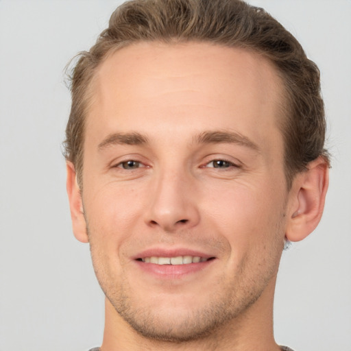 Joyful white adult male with short  brown hair and brown eyes