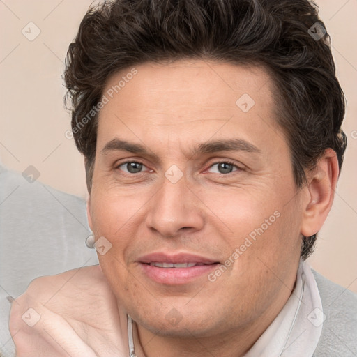 Joyful white adult male with short  brown hair and brown eyes