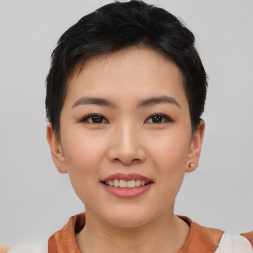 Joyful asian young-adult female with short  brown hair and brown eyes