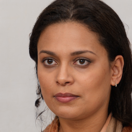 Neutral black young-adult female with long  brown hair and brown eyes