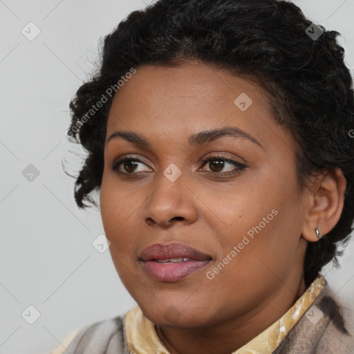 Joyful black young-adult female with short  black hair and brown eyes