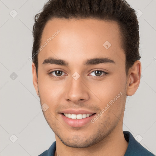 Joyful white young-adult male with short  brown hair and brown eyes