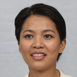 Joyful asian young-adult female with short  brown hair and brown eyes