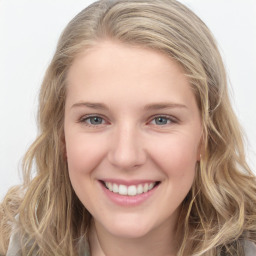 Joyful white young-adult female with long  brown hair and blue eyes