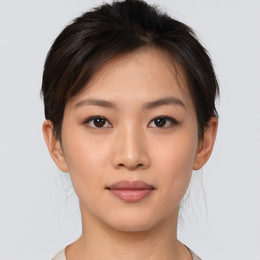 Joyful asian young-adult female with short  brown hair and brown eyes