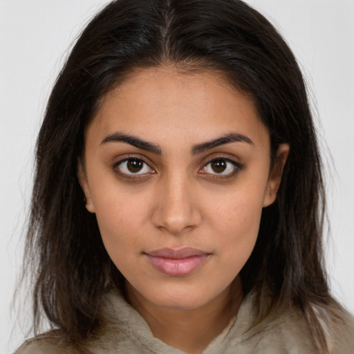 Joyful latino young-adult female with long  brown hair and brown eyes