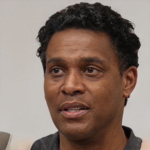 Neutral black adult male with short  black hair and brown eyes