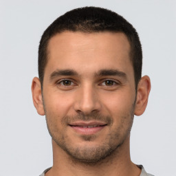 Joyful white young-adult male with short  brown hair and brown eyes