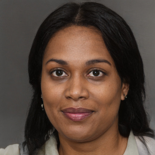 Joyful black adult female with medium  black hair and brown eyes