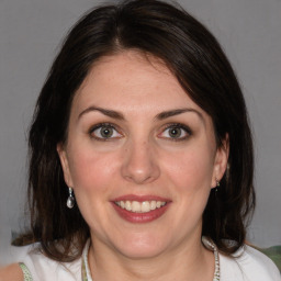 Joyful white adult female with medium  brown hair and brown eyes