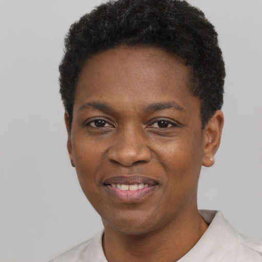 Joyful black young-adult female with short  black hair and brown eyes