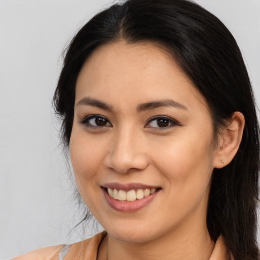 Joyful asian young-adult female with long  brown hair and brown eyes