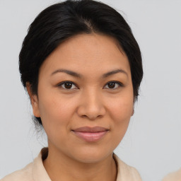 Joyful latino young-adult female with medium  brown hair and brown eyes