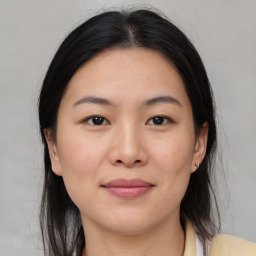 Joyful asian young-adult female with medium  brown hair and brown eyes