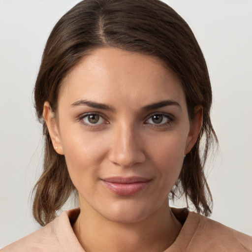 Joyful white young-adult female with medium  brown hair and brown eyes