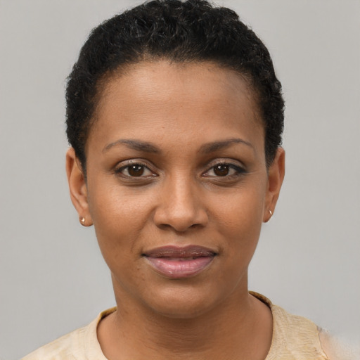 Joyful black young-adult female with short  black hair and brown eyes