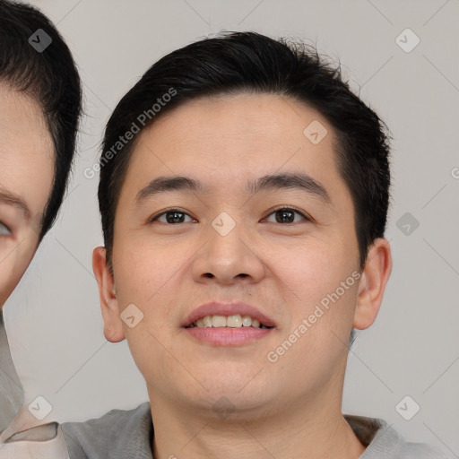 Joyful asian young-adult male with short  brown hair and brown eyes