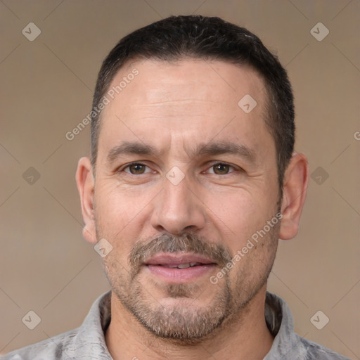 Joyful white adult male with short  black hair and brown eyes