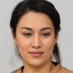 Joyful asian young-adult female with medium  brown hair and brown eyes