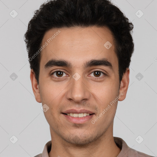 Joyful white young-adult male with short  black hair and brown eyes