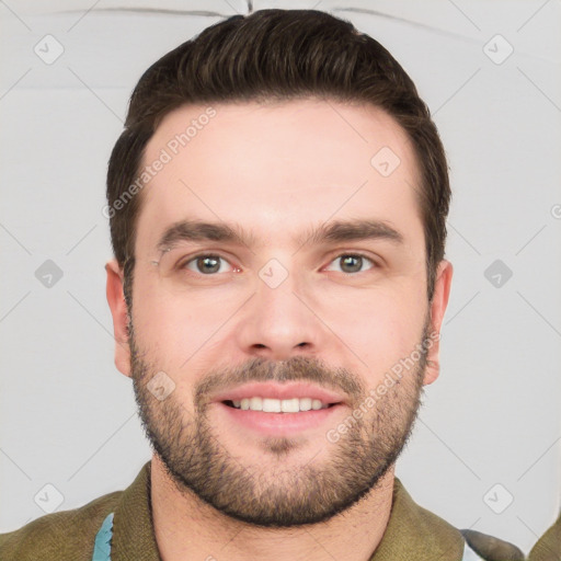 Joyful white young-adult male with short  brown hair and grey eyes