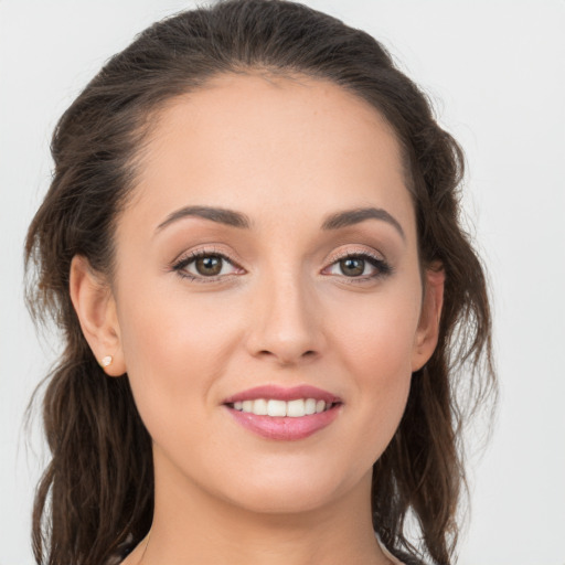 Joyful white young-adult female with medium  brown hair and grey eyes