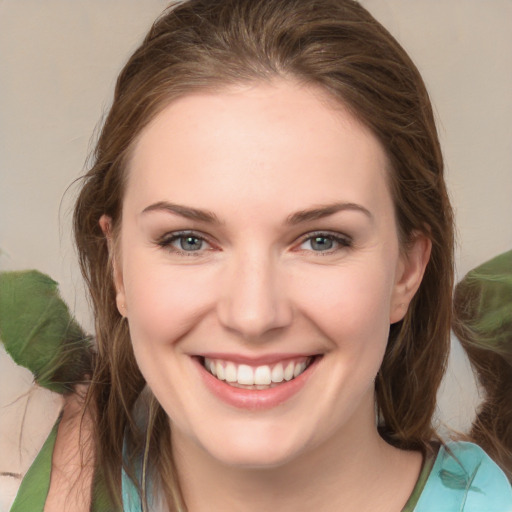 Joyful white young-adult female with medium  brown hair and green eyes