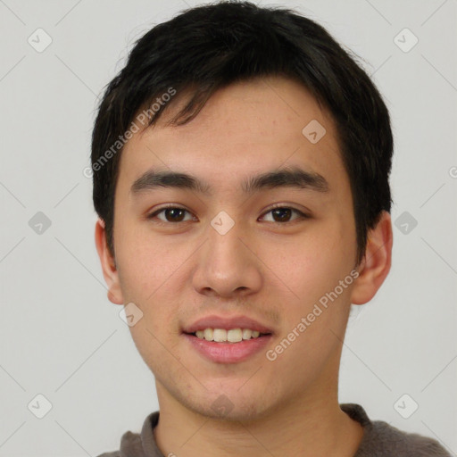 Joyful white young-adult male with short  black hair and brown eyes