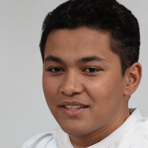 Joyful white young-adult male with short  black hair and brown eyes