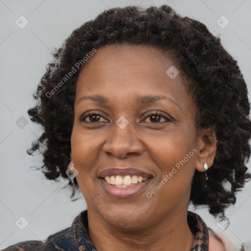 Joyful black adult female with medium  brown hair and brown eyes